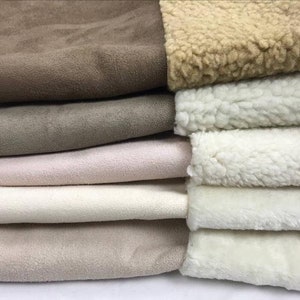 May include: A stack of fabric swatches in various shades of brown, beige, and white. The top swatch is a brown suede fabric, and the bottom swatches are a white faux fur fabric.