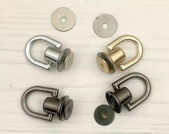 May include: Four metal swivel snap hooks with a loop and a screw-on base. The hooks are in silver, gold, and black.