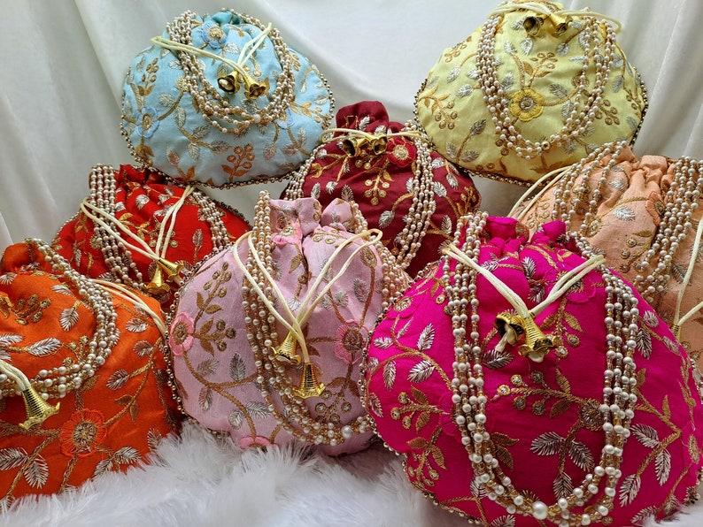 Ethnic embroidered potli handbags in bright multicolor shades with intricate floral patterns and pearl embellishments, handmade Indian wedding favor bags for guests, stylish drawstring pouch for brides, bridesmaids and party wear, perfect for gifting, storage or fashion use, traditional yet modern accessory loved by USA customers, premium quality silk potli purse for festive and cultural occasions