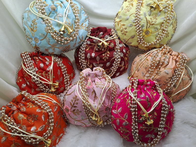 Multicolor embroidered Indian potli bags with pearl handles, handcrafted silk drawstring purses featuring intricate floral zari embroidery in pink, red, yellow, blue and orange shades, traditional ethnic handbags perfect for Indian weddings, bridal accessories, bridesmaid gifts, festive celebrations, party wear and return gift pouches, lightweight stylish pouch bags for women, boho chic fashion accessory for USA buyers looking for unique handmade gifts
