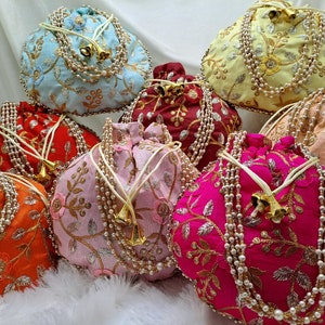 Handmade Indian potli purse set with rich silk fabric and detailed floral embroidery, pearl string handles and drawstring closure, vibrant traditional pouch bags ideal for wedding favors, bridesmaid gifts, bridal shower, mehndi and haldi ceremonies, ethnic clutch alternative for women, reusable gift bags, designer potli handbags for festive occasions, cultural fashion accessory trending in USA for weddings and special events