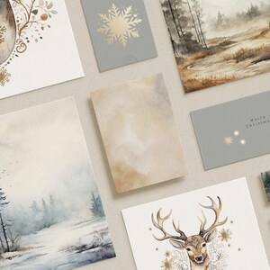 May include: A selection of watercolour Christmas cards and envelopes. The cards display winter scenes, a deer, and snowflake designs in gold and neutral tones. One envelope reads "Merry Christmas".