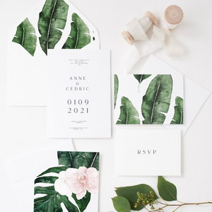 May include: Wedding invitation suite with a tropical theme. The invitation features a watercolor illustration of banana leaves and the text "Anne & Cedric 01.09.2021". The RSVP card features a simple "RSVP" in a minimalist font.