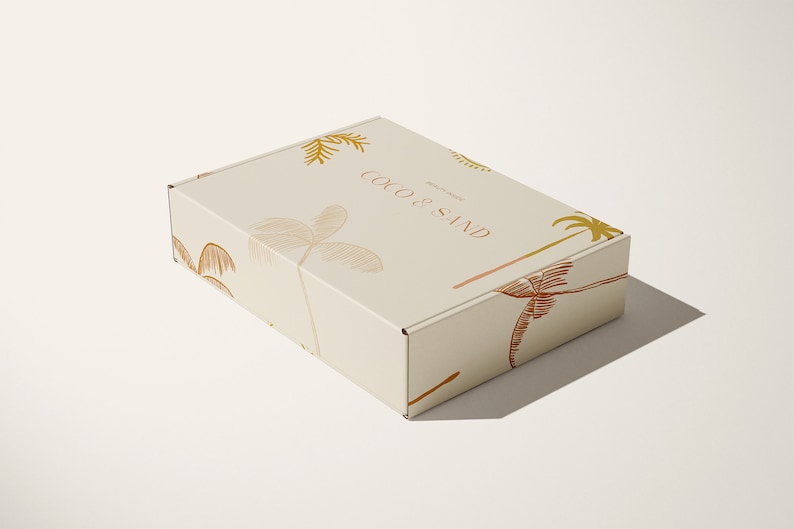 May include: A beige cardboard box with a palm tree design and the text "Coco & Sand" printed on the top.
