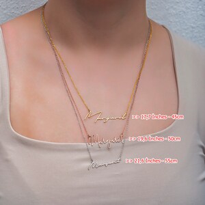 May include: Three gold, silver, and rose gold necklaces with the name "Margaret" written in cursive on each. The necklaces are shown on a model wearing a beige top. The necklaces are available in three lengths: 17.7 inches (45 cm), 19.6 inches (50 cm), and 21.6 inches (55 cm).