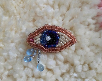 navy blue right eye brooch