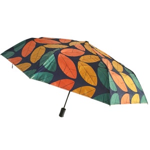 May include: A blue umbrella with a colorful leaf pattern. The leaves are orange, yellow, and green.
