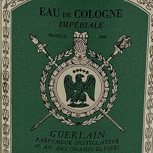 May include: A green and white label with the text "EAU DE COLOGNE IMPERIALE" and "GUERLAIN PARFUMEUR DISTILLATEUR 68. AV. DES CHAMPS-ELYSEES". The label features a crest with a bird and a laurel wreath.
