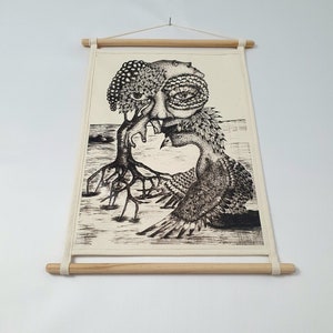 May include: Black and white ink drawing of a tree with a human face and a bird with a human face. The tree has roots and the bird has wings. The drawing is on a canvas with a wooden frame.