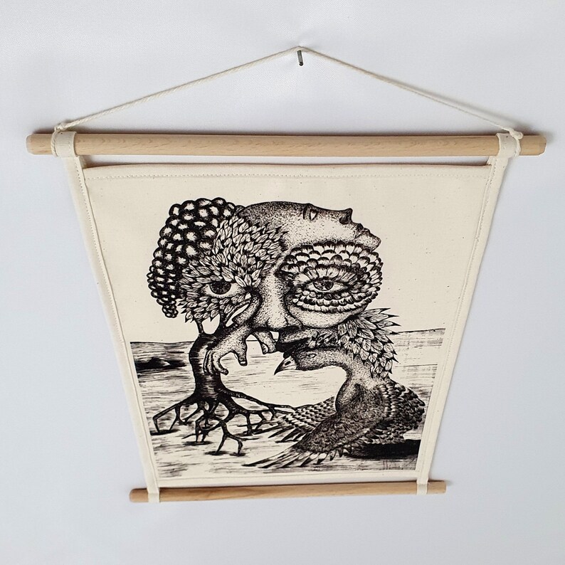 May include: Black and white illustration of a surreal creature with a tree growing out of its head. The creature has a large eye and is surrounded by leaves and branches. The illustration is printed on a white canvas and framed with a wooden frame.