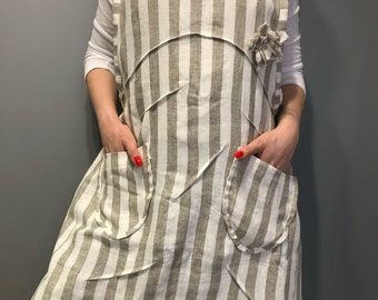 Striped linen apron in boho style with decoration in the form of flowers from fabric