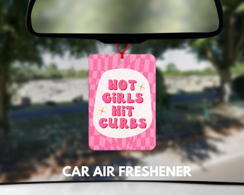 May include: Pink car air freshener with a checkered pattern and the text "HOT GIRLS HIT CURBS".
