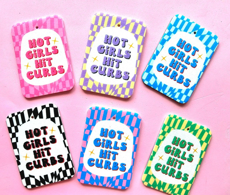 May include: Six colorful air fresheners with a checkered pattern and the text "Hot Girls Hit Curbs".