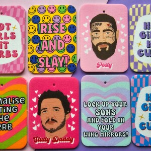 May include: Ten colorful car air fresheners with various designs and text. The designs include smiley faces, hearts, and checkered patterns. The text includes "Hot Girls Hit Curbs", "Rise and Slay", "Lock Up Your Sons and Fold In Your Wing Mirrors", "Normalize Hitting the Kerb", and "Slutty Daddy".