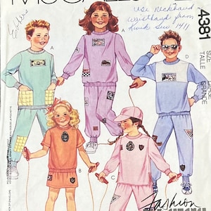 May include: A sewing pattern for children's clothing. The pattern includes four different designs for a sweatshirt and pants. The pattern is for size large and is from Kwik Sew 1411. The pattern is called "Fashion Basics".