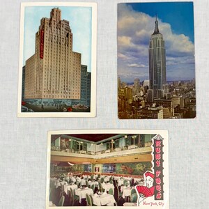May include: Three vintage postcards featuring New York City landmarks. One shows the Wellington Hotel, another the Empire State Building, and the third, Ruby Foo's restaurant. Each card has a colorful illustration of the buildings and scenes.