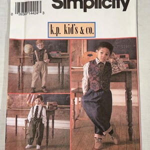 May include: Simplicity sewing pattern for children's clothing, size BB (5-8). The pattern features a collage of children in school attire. The pattern includes the text "k.p. kid's & co." and "PATTERN/PATRON".