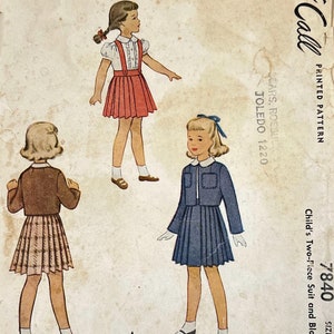 May include: Vintage sewing pattern for a child's two-piece suit and blouse. The pattern is for sizes 6 and 35. The pattern shows three illustrations of girls wearing the suit and blouse. The suit is a blue skirt and jacket, and the blouse is white with a Peter Pan collar. The pattern is from the Call Printed Pattern company.