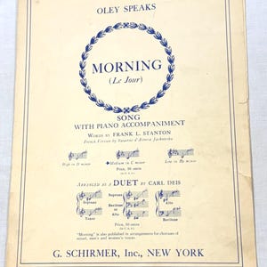 May include: A vintage sheet music cover for the song Morning by Oley Speaks, featuring blue text and a floral wreath graphic on a cream-colored background. The document includes musical notation, credits for Frank L. Stanton, and publisher details.