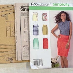 May include: Simplicity sewing pattern 1465, featuring skirt designs. The pattern packet includes a photo of a woman wearing a red lace skirt. The packet also shows various skirt styles, including a ruffled skirt and a wrap skirt.