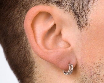 May include: A silver filigree hoop earring for a single ear.