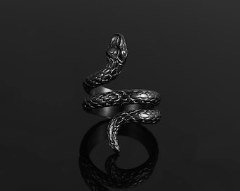 May include: A black snake ring with a coiled design. The ring is made of metal and has a textured finish.