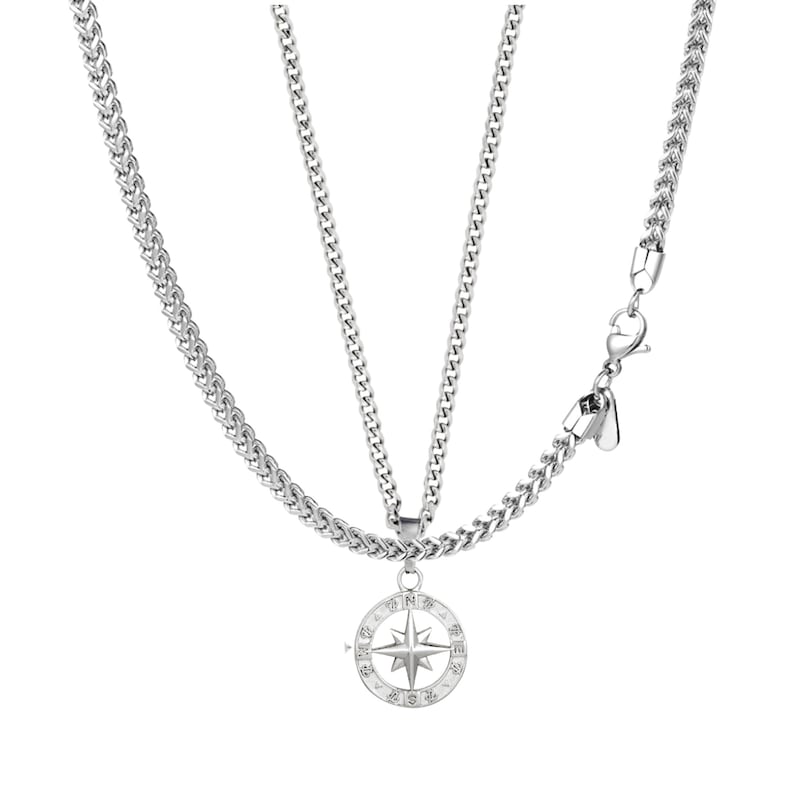 May include: A silver-toned necklace with a compass pendant. The pendant features a star design and is surrounded by a circular frame. The necklace has a chain-link style and a clasp closure.