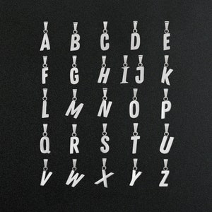 May include: A set of 26 silver letter charms, each featuring a different letter of the alphabet. The charms are arranged in alphabetical order on a black background.