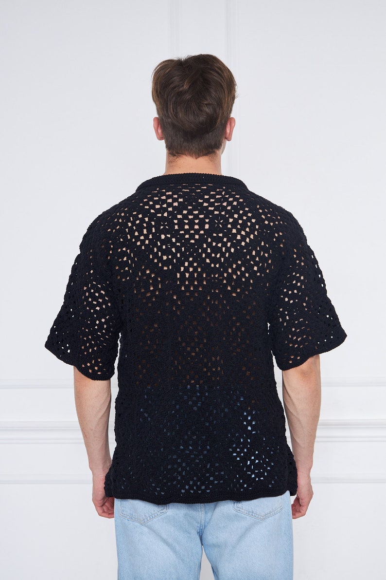 May include: A black crochet shirt with a loose fit and short sleeves. The shirt has a square pattern and is made of a lightweight material.