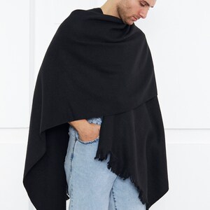 May include: A black fringed shawl with a small black label that says "BOSS" in white lettering.