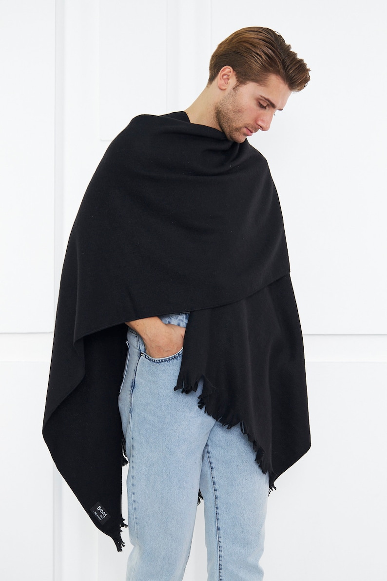 May include: A black fringed shawl with a small black label that says "BOSS" in white lettering.