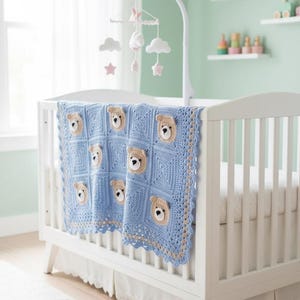 May include: A light blue crochet baby blanket featuring a repeating square pattern with beige and white bear face appliques. The blanket has a decorative scalloped border in blue and beige and is draped over the side of a white wooden crib.