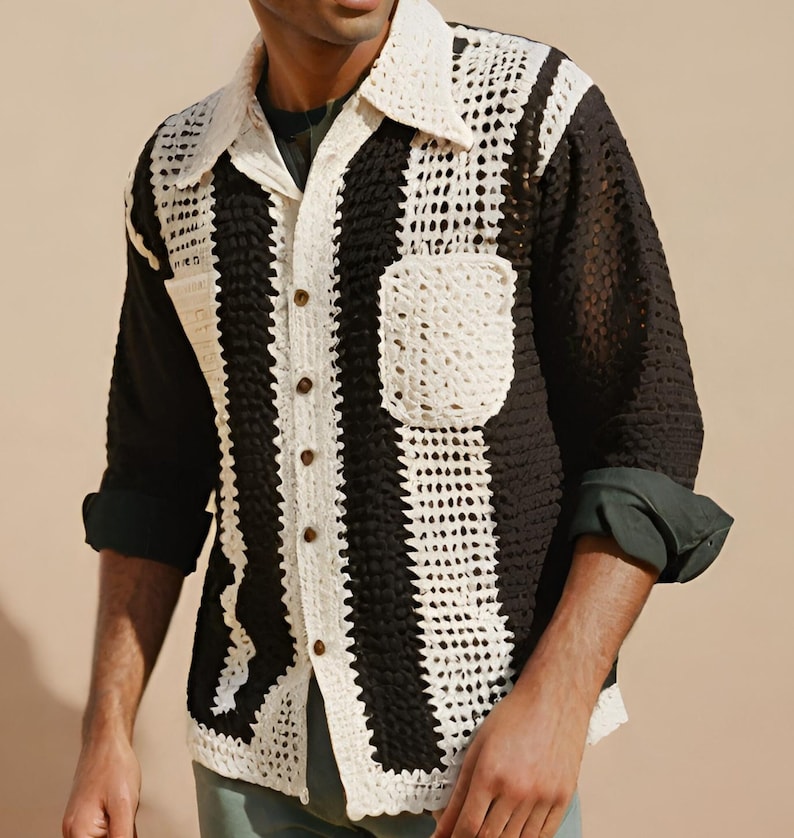 May include: A black and white crocheted long-sleeved shirt with a button-up front and a pocket on the left side.