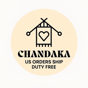 May include: A circular logo with a light beige background features a black line art design of a heart-shaped emblem with knitting needles. The word "CHANDAKA" is below the emblem in a bold, black font.
