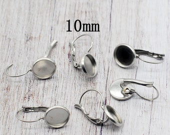 May include: Five silver earring blanks with 10mm round bezels. The earring blanks are made of metal and have a hook closure.