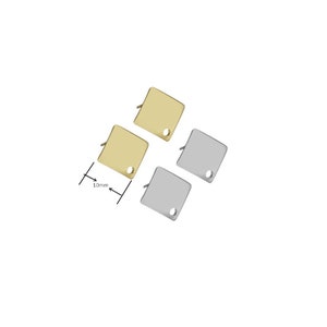 May include: Three square metal charms with a hole in the center. Two charms are gold and one is silver. The charms are 10mm in size.