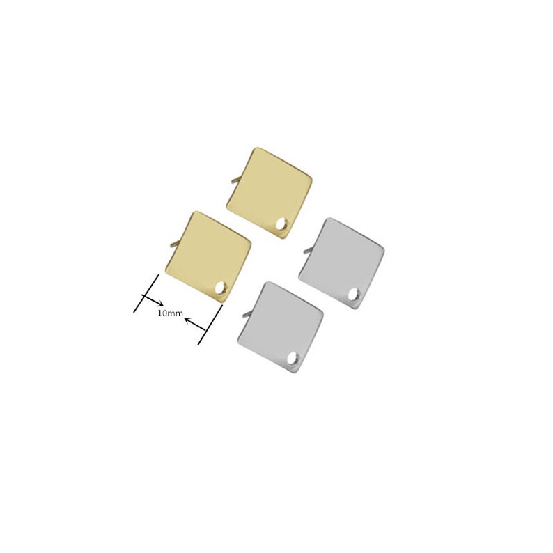 May include: Three square metal charms with a hole in the center. Two charms are gold and one is silver. The charms are 10mm in size.