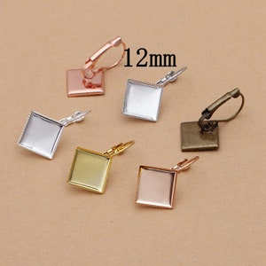 May include: Five pairs of 12mm square earring settings with clip-on backs. The settings are in silver, gold, rose gold, and bronze.