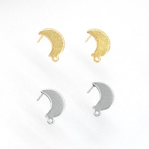May include: Two pairs of crescent moon shaped earring findings. One pair is gold and the other is silver.