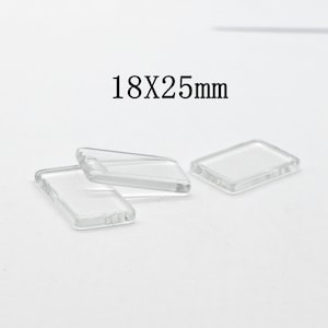 May include: Three clear glass rectangular tiles, each measuring 18 by 25 millimeters. The tiles are arranged on a white surface.