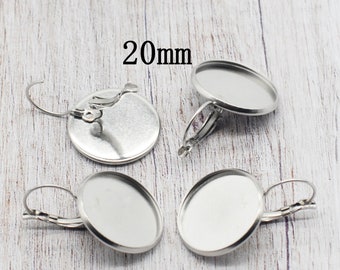 May include: Four silver earring blanks with a 20mm round bezel. The earring blanks have a clip-on style closure.