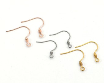 May include: Six earring hooks in three different colours: gold, rose gold, and silver. The hooks are made of metal and have a small loop at the top.