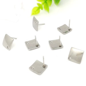 May include: Six silver square earring blanks with posts. The earring blanks are smooth and have a hole in the center.