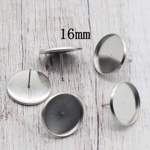 May include: Several silver-coloured earring posts with a flat, round bezel, each measuring 16mm (approx. 0.6 inches). These posts are for crafting earrings, with a simple, metallic design. The image shows multiple pieces, emphasising the design and size.