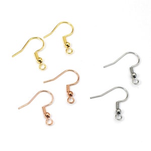 May include: Six earring hooks in three different colors: gold, silver, and rose gold. Each hook has a small ball at the end.