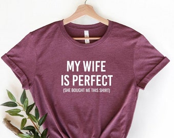 May include: Heather maroon t-shirt with the text "My wife is perfect (She bought me this shirt)" in white.