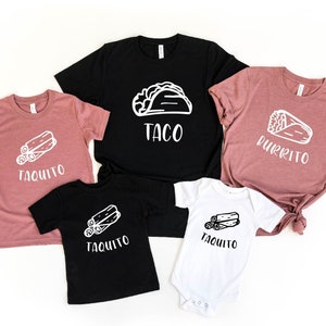 May include: A set of four t-shirts featuring different Mexican food items. The shirts are black and pink with white text and graphics. The shirts say "Taco", "Burrito", and "Taquito".