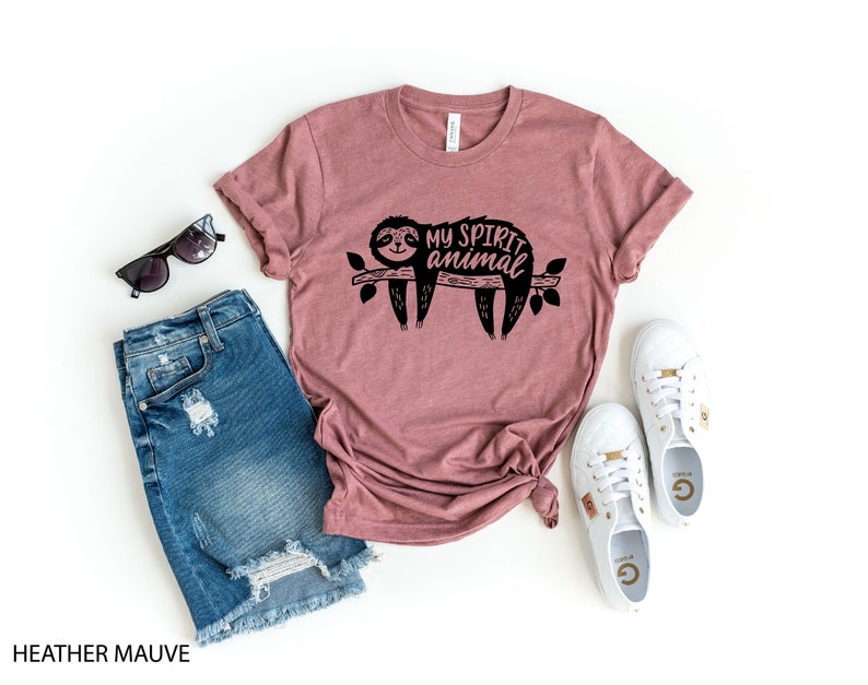 May include: Heather mauve t-shirt with a black graphic of a sloth on a branch with the text "My spirit animal".