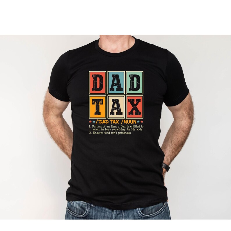 May include: Black t-shirt with a retro-style graphic that says "DAD TAX" and defines it as a "portion of an item a Dad is entitled to when he buys something for his kids" and "ensures food isn't poisonous".