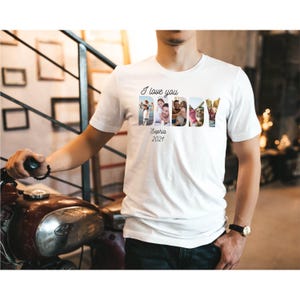 May include: White t-shirt featuring the text "I love you DADDY" in black script. The word "DADDY" is composed of family photos. The name "Sophia" and the year "2021" are printed below.